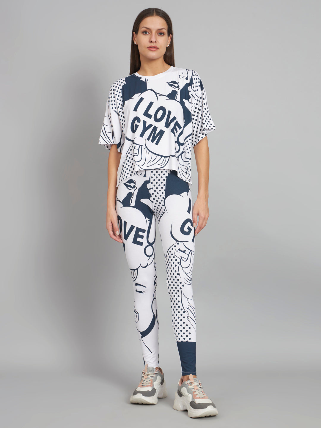Woman wearing a white and blue 'I Love Gym' outfit on a gray background