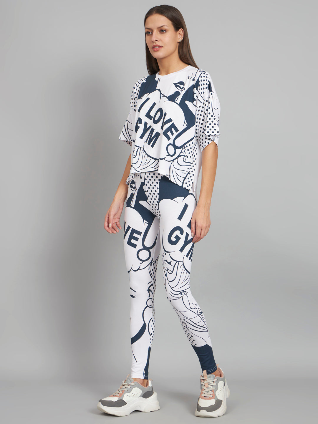 Woman wearing a white and blue 'I Love Gym' outfit on a gray background