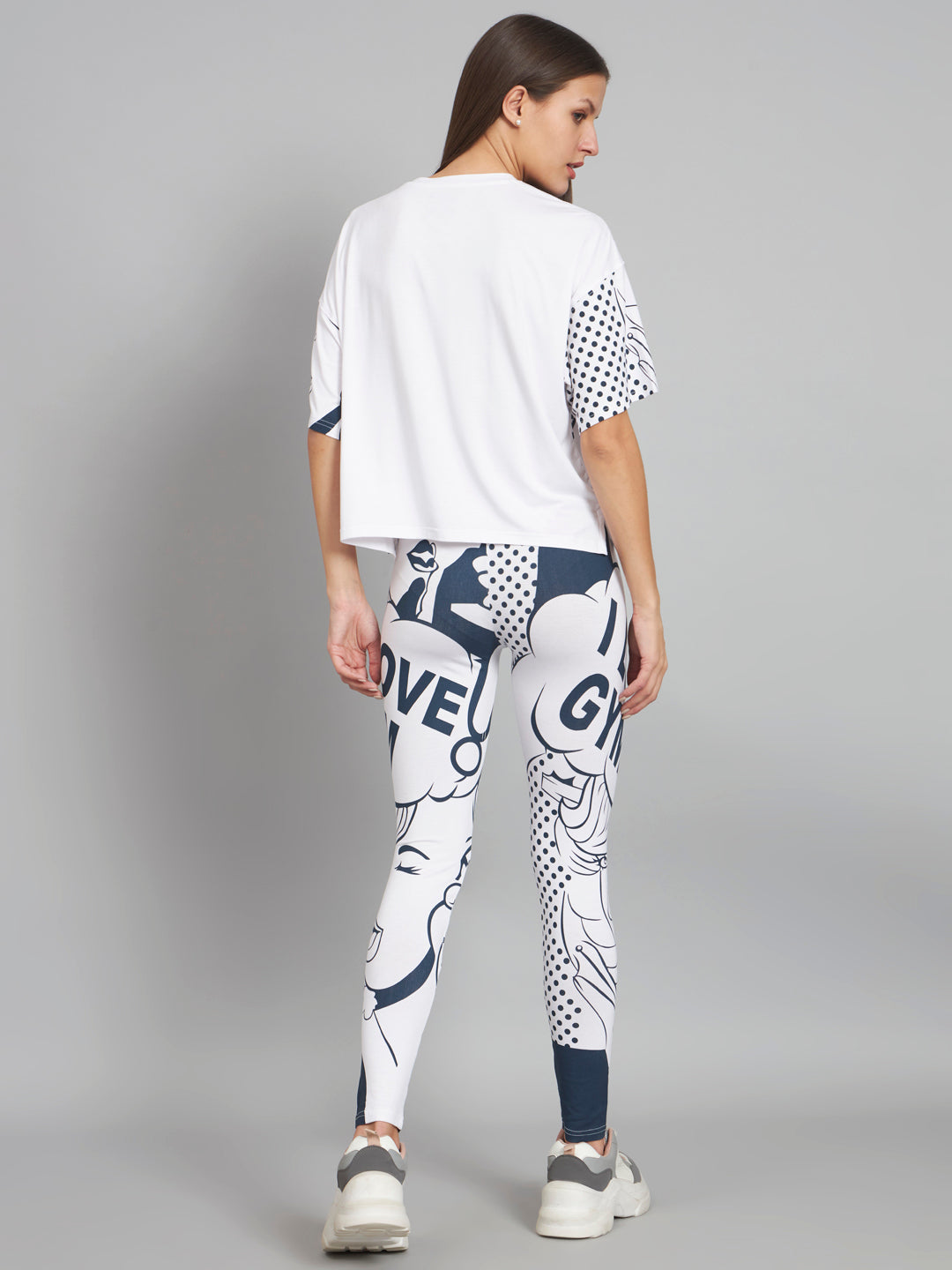 Person wearing a white t-shirt and GYM  leggings on a gray background